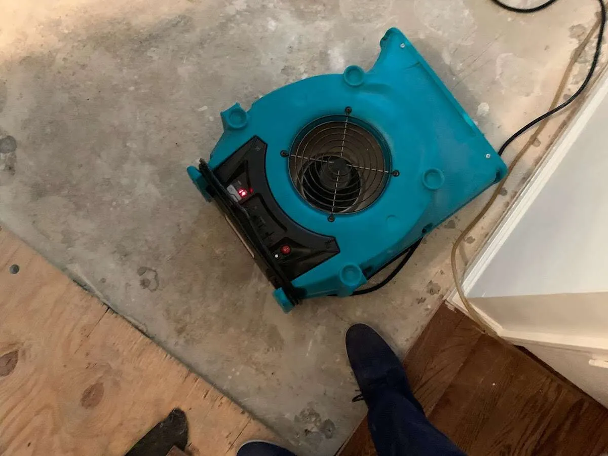 Air mover drying subfloor during Commercial Water Damage Restoration in Oakland Park